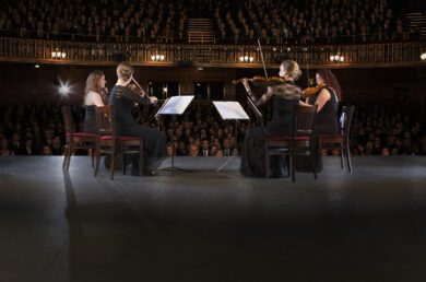 Orchestra quartet performing in front of audience