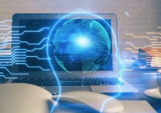 Worktable with computer, digital brain and globe superimposed