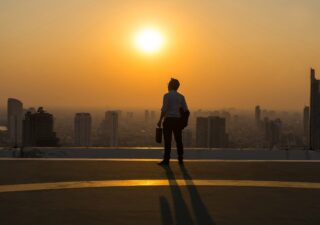 business man looking into the sunset