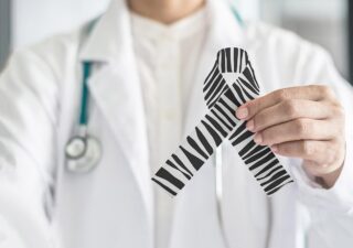 Doctor Holding Rare Disease Ribbon