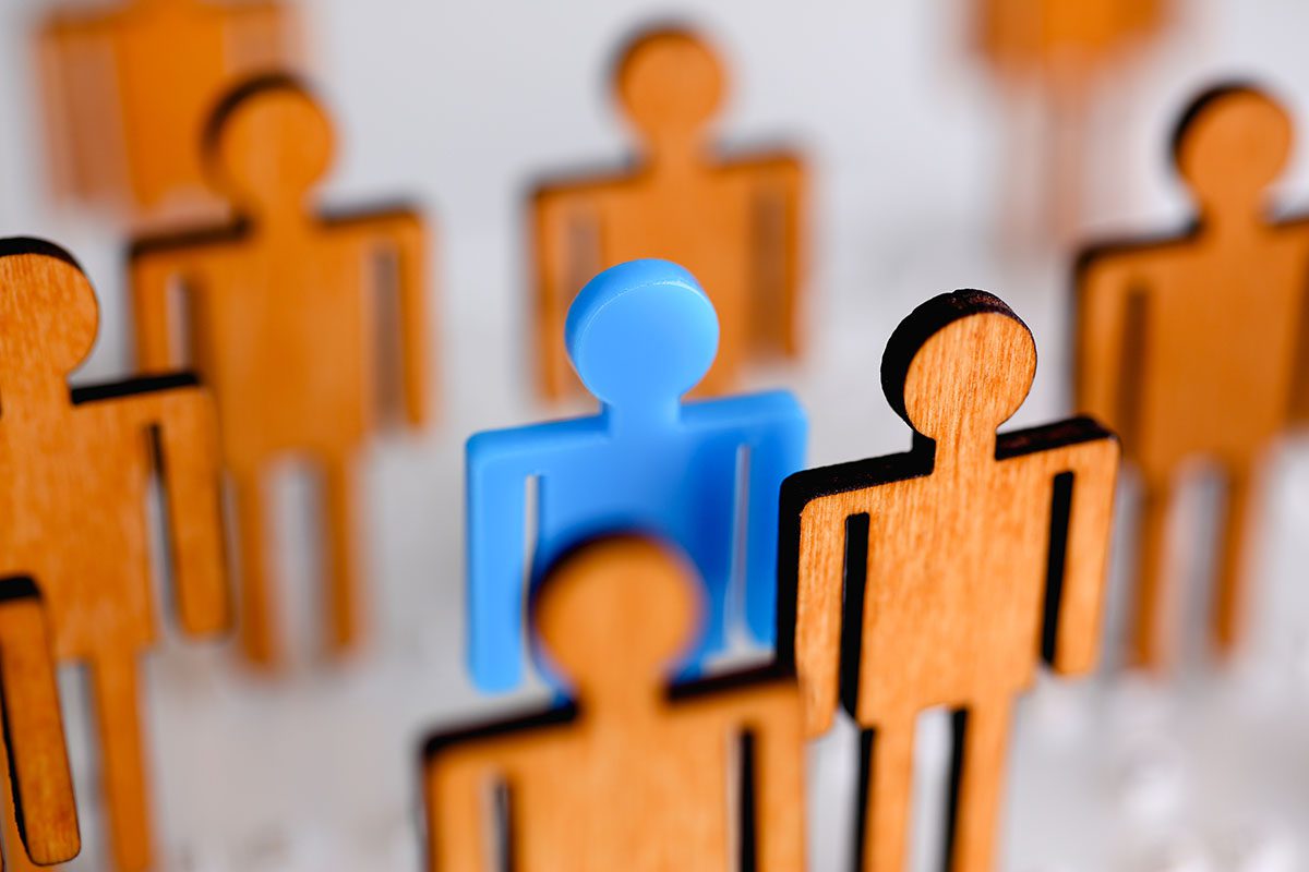 Blue Person highlighted in a group of monochromatic people