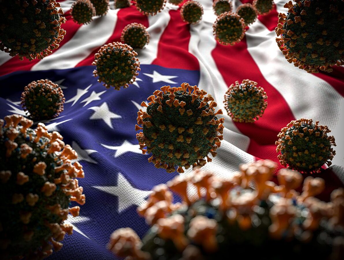 COVID-19 virus cells in front of an American flag